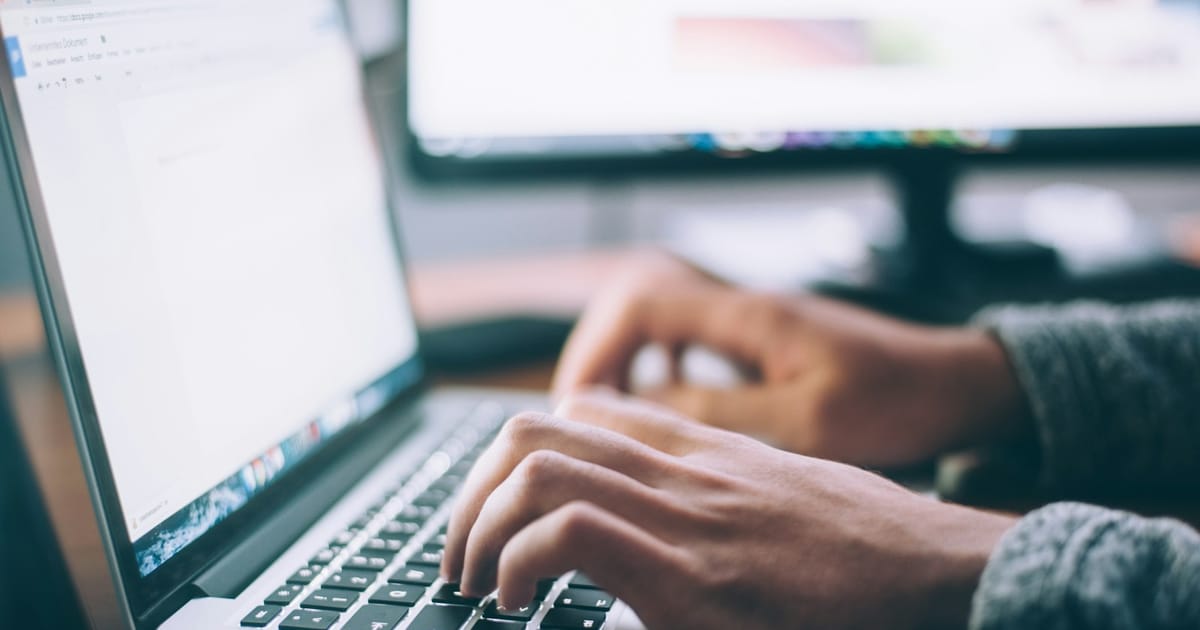 Person typing on a laptop at a desk