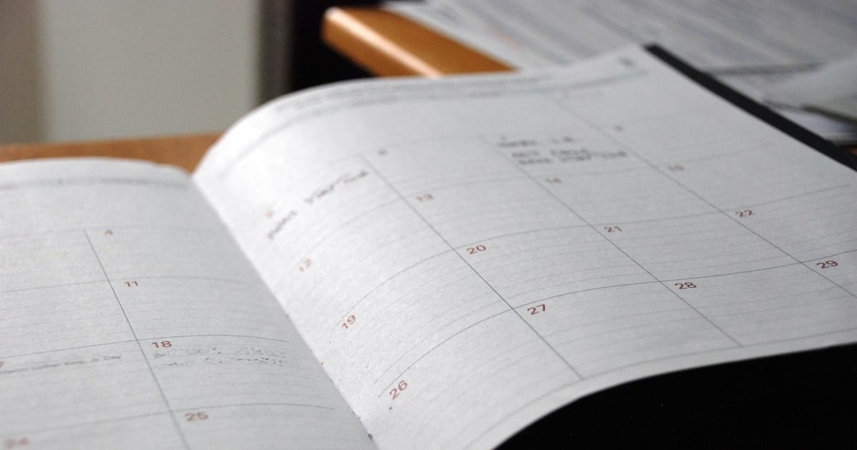 Open monthly planner on a wooden desk