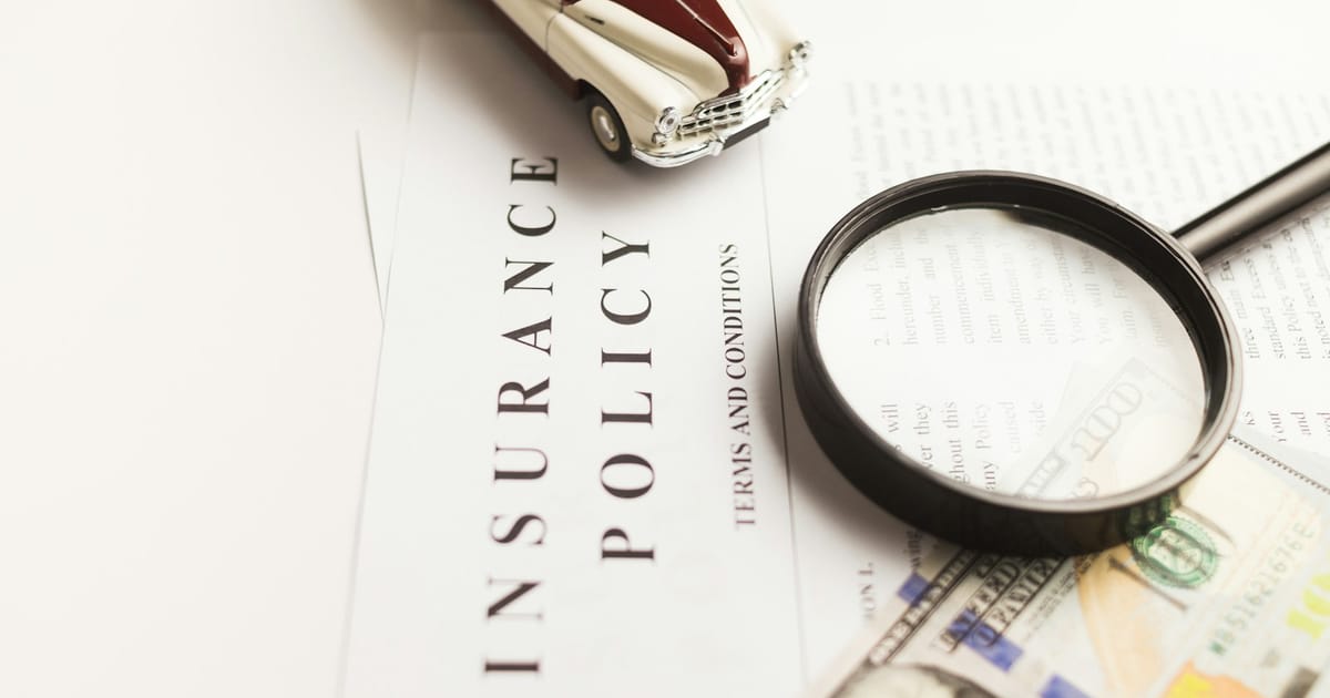 Magnifying glass on an insurance policy document