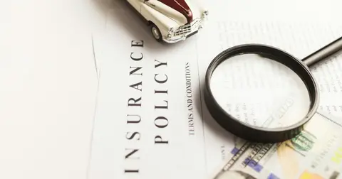 Magnifying glass on an insurance policy document